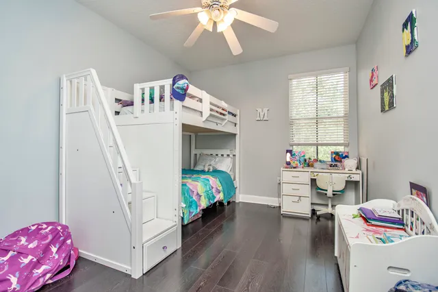a bedroom with furniture and a wooden floor
