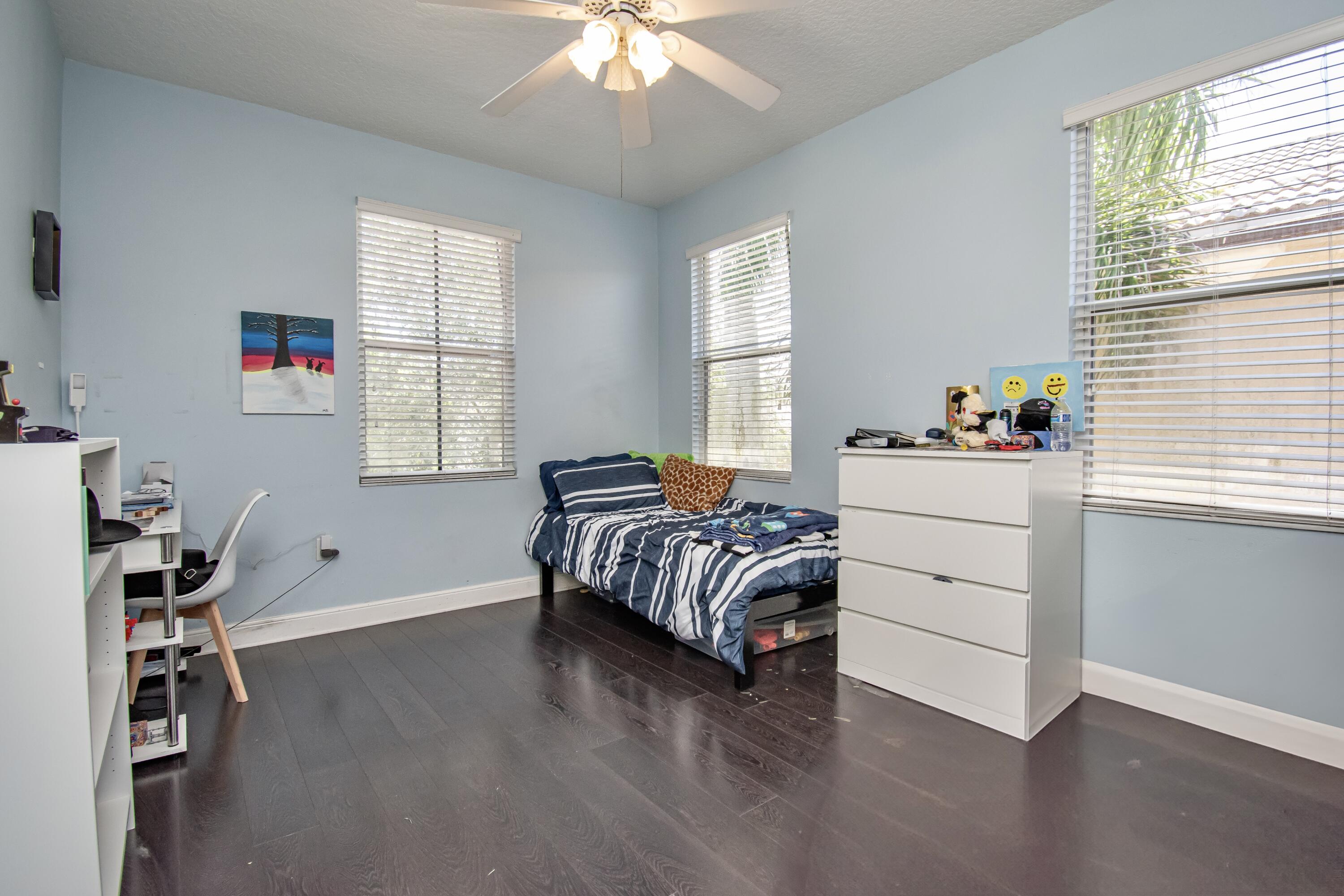 9851 Palma Vista Way Boca Raton, FL 33428 - Photo 29 of 33 a bedroom with a bed and a window