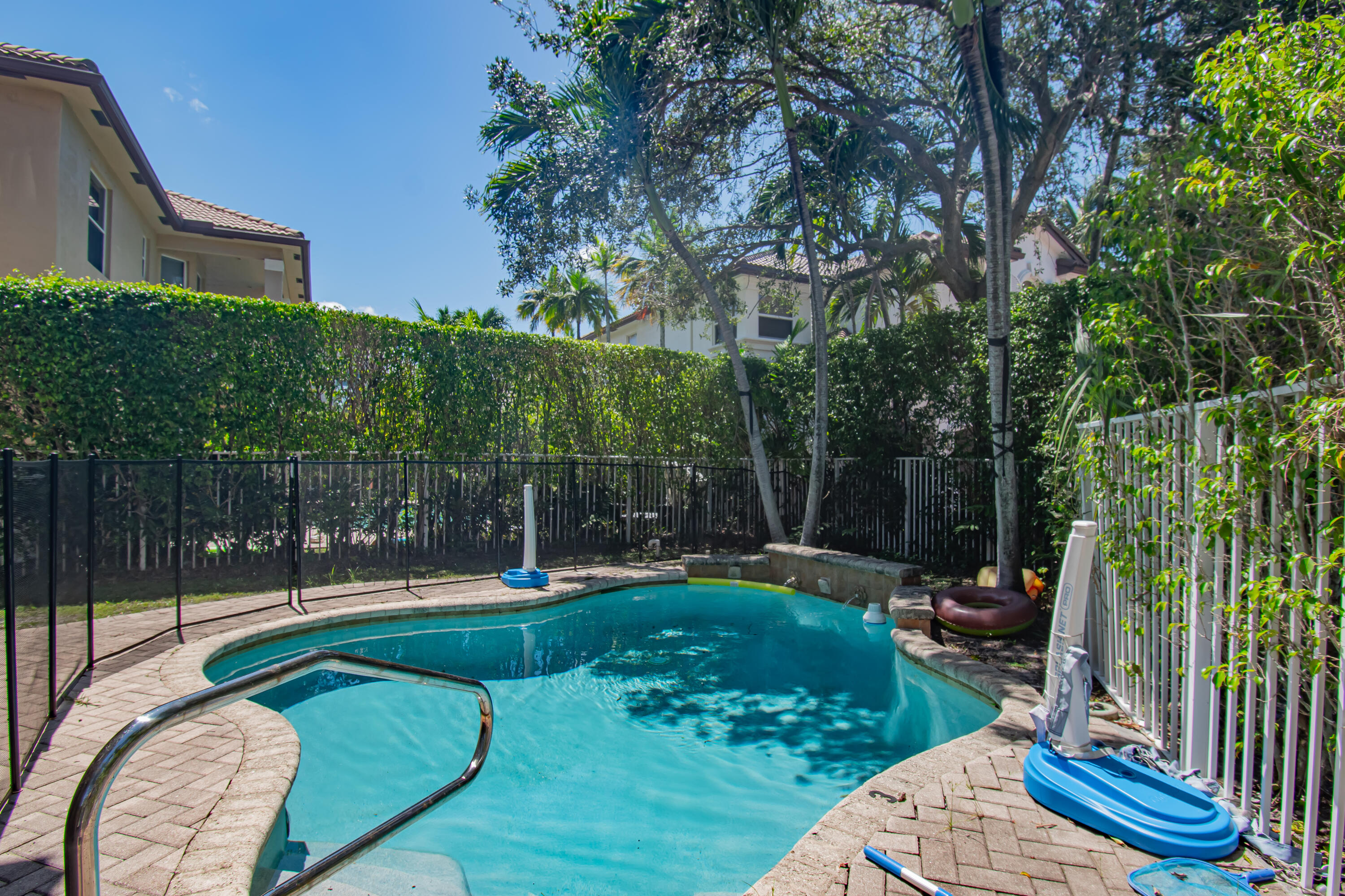 9851 Palma Vista Way Boca Raton, FL 33428 - Photo 31 of 33 a view of a backyard with couches potted plants and wooden fence