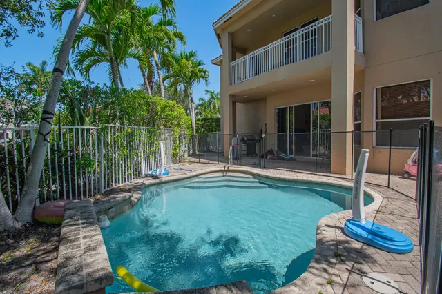 a swimming pool with patio outdoor seating and yard