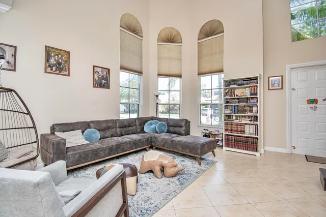 a living room with furniture and a book shelf