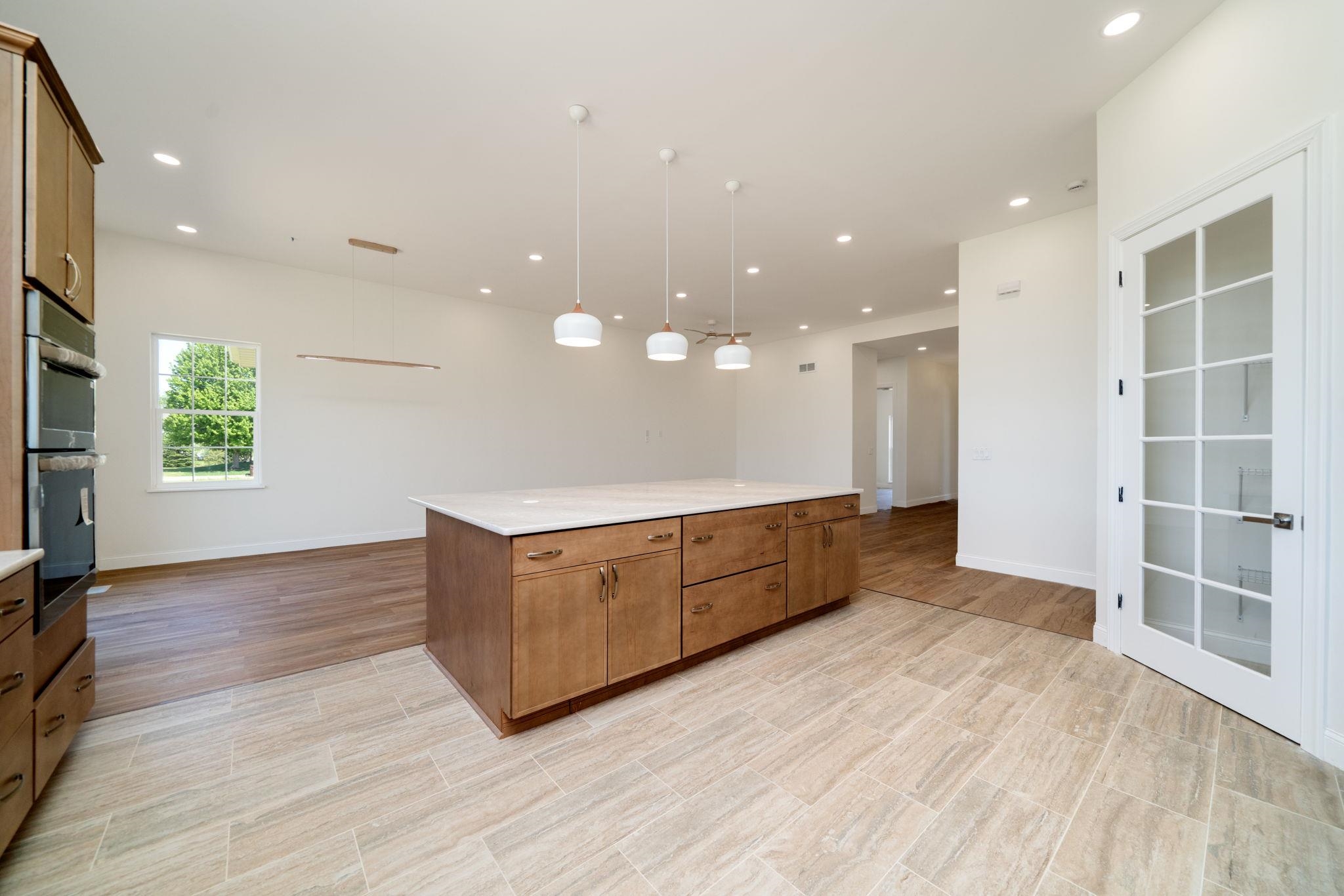 5145 Sycamore Ridge Road Belvidere, IL 61008 - Photo 20 of 57 a large kitchen with stainless steel appliances a large counter top and a wooden floors