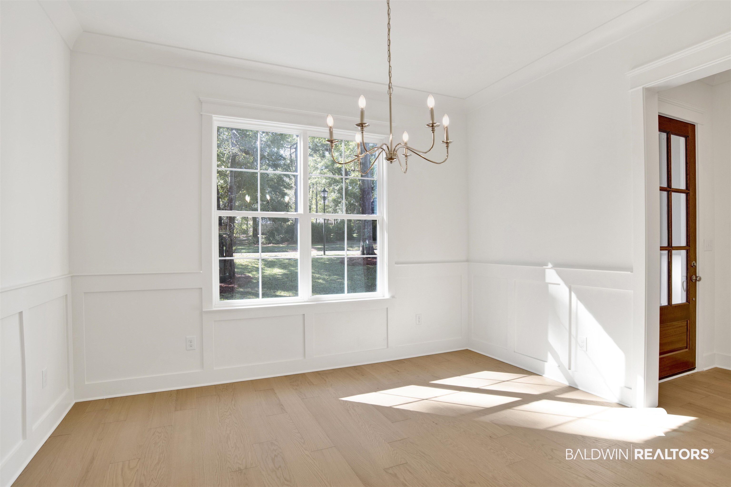 5 Long Leaf Circle Fairhope, AL 36532 - Photo 17 of 44 Unfurnished dining area featuring a chandelier, light hardwood / wood-style flooring, and crown molding