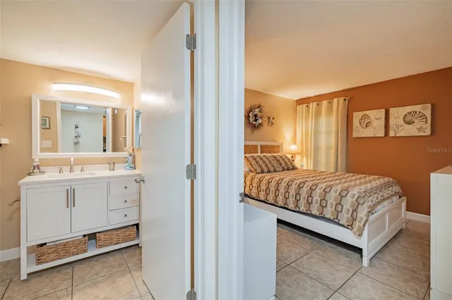 a bedroom with a bed and a mirror