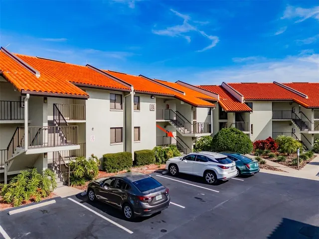 a view of a house with wooden deck and furniture