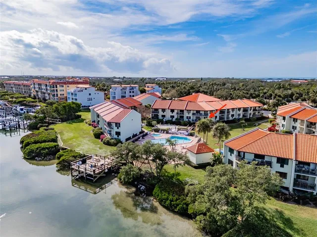 a view of a swimming pool with outdoor seating and plants
