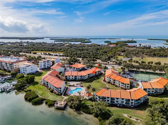 a view of a pool with lawn chairs