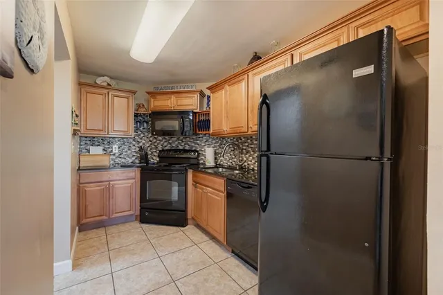 a kitchen with a refrigerator and a stove