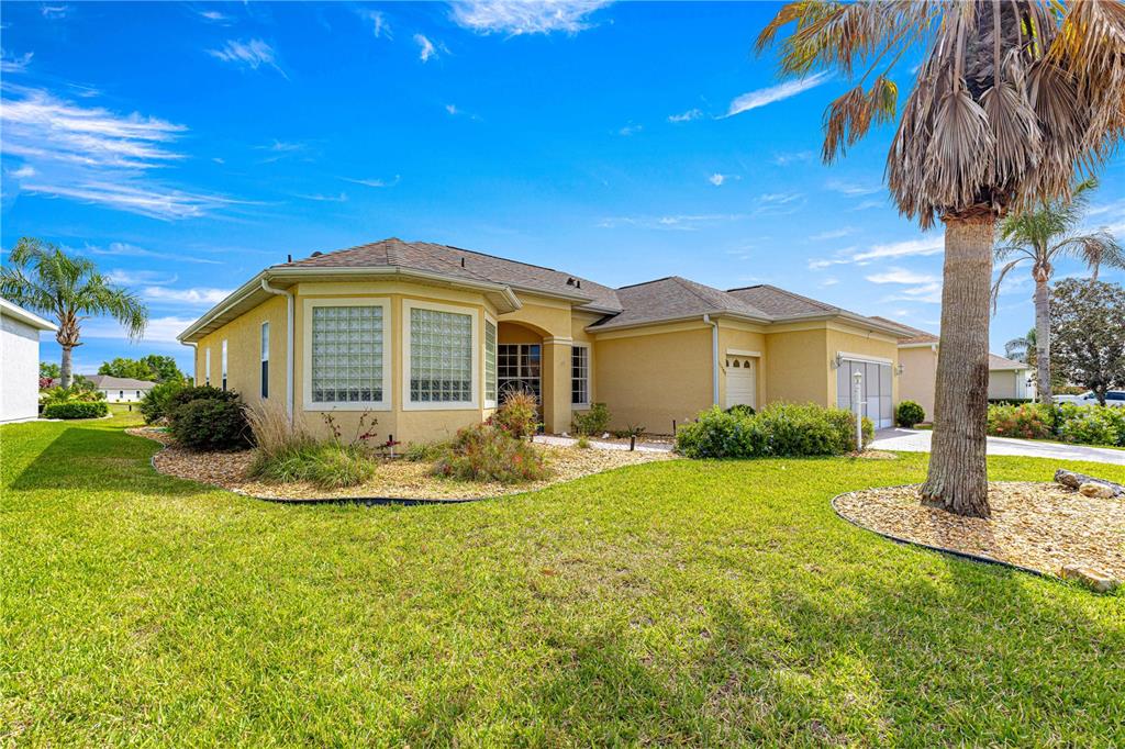 11799 Southeast 173rd Ln Road Summerfield, FL 34491 - Photo 2 of 83 a front view of a house with garden