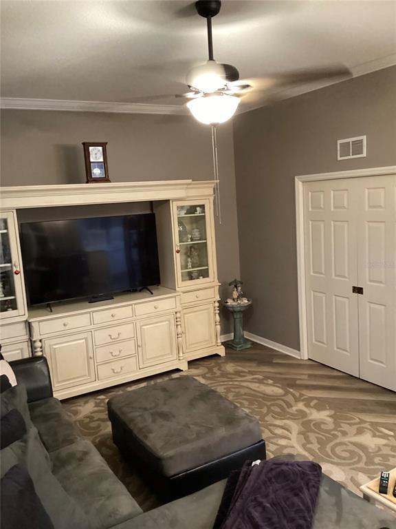 11799 Southeast 173rd Ln Road Summerfield, FL 34491 - Photo 21 of 83 a living room with a flat screen tv and a view of bedroom