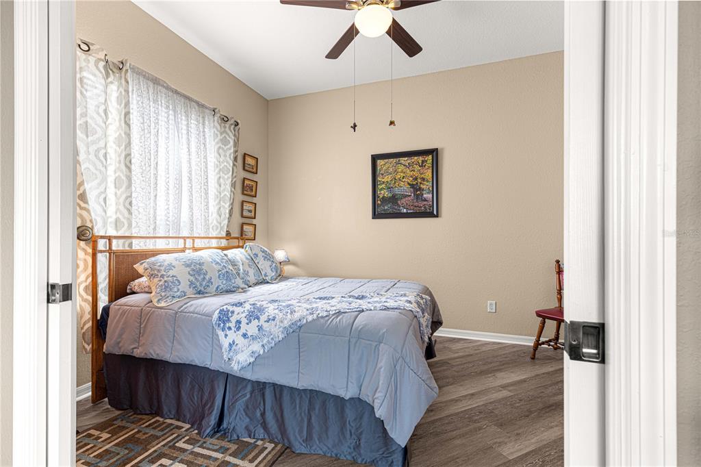 11799 Southeast 173rd Ln Road Summerfield, FL 34491 - Photo 23 of 83 a bedroom with a bed and a painting on the wall