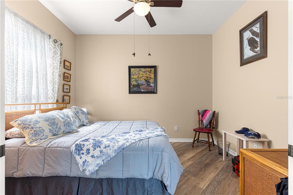 11799 Southeast 173rd Ln Road Summerfield, FL 34491 - Photo 24 of 83 a bedroom with a bed and a dresser