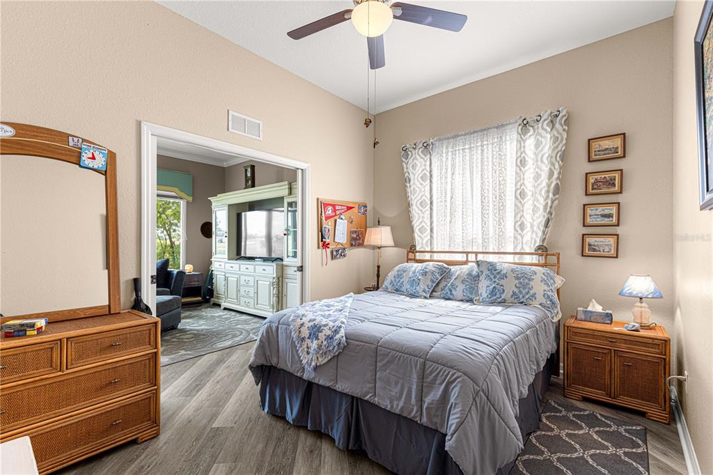 11799 Southeast 173rd Ln Road Summerfield, FL 34491 - Photo 25 of 83 a bedroom with a bed and wooden floor