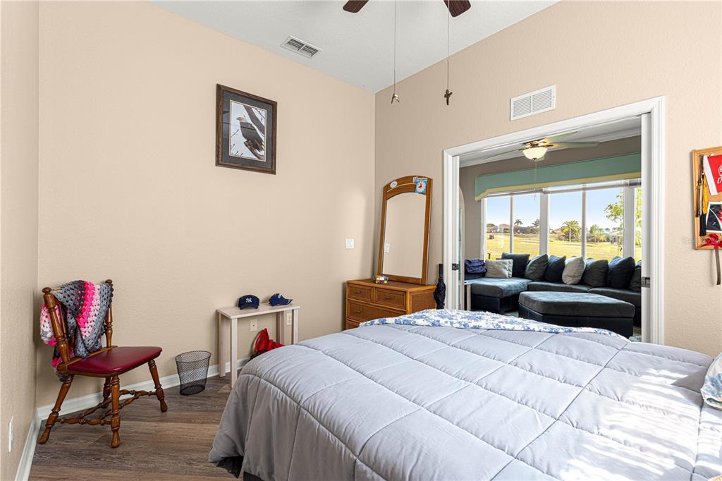 11799 Southeast 173rd Ln Road Summerfield, FL 34491 - Photo 26 of 83 a bedroom with a bed and a chair