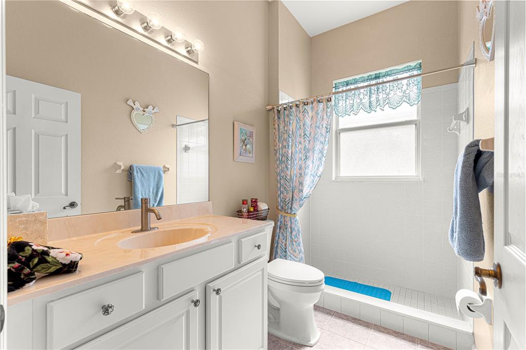 11799 Southeast 173rd Ln Road Summerfield, FL 34491 - Photo 30 of 83 a bathroom with a sink a toilet and a mirror