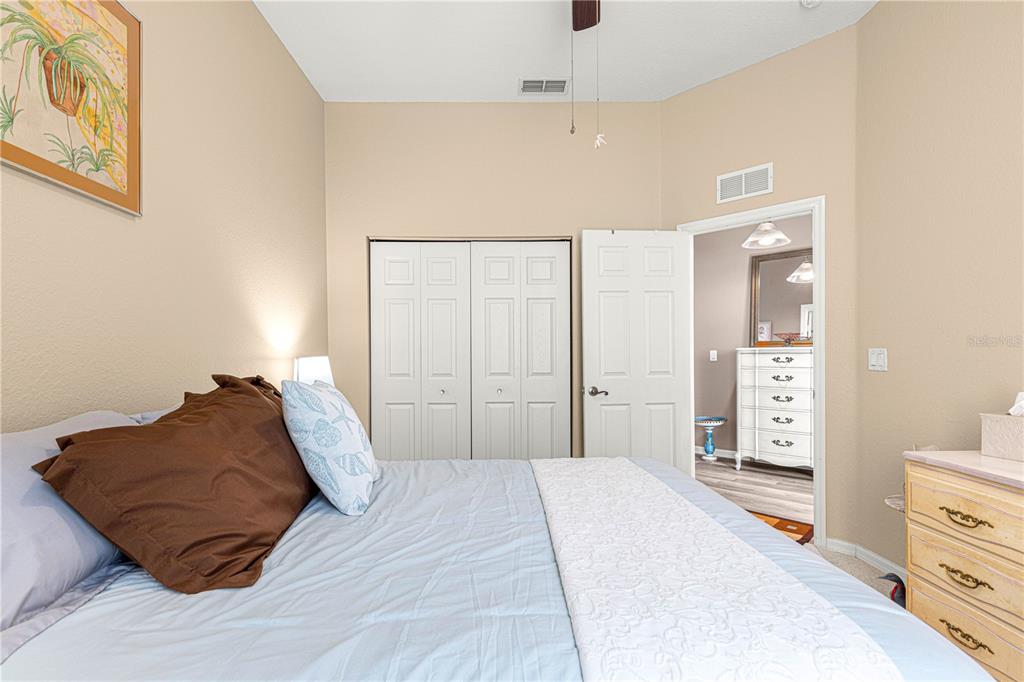 11799 Southeast 173rd Ln Road Summerfield, FL 34491 - Photo 32 of 83 a bedroom with a bed and a lamp