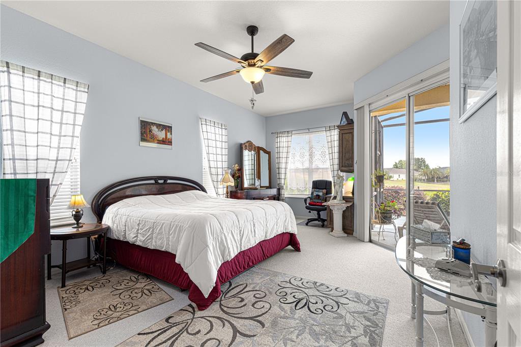 11799 Southeast 173rd Ln Road Summerfield, FL 34491 - Photo 33 of 83 a bedroom with a large bed and a large window