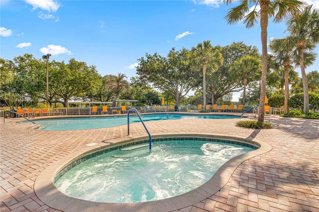 11799 Southeast 173rd Ln Road Summerfield, FL 34491 - Photo 75 of 83 a view of a swimming pool with a yard and palm trees