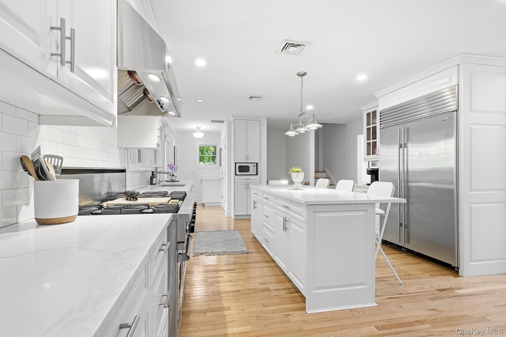 60 Hillside Lane New Rochelle, NY 10804 - Photo 12 of 44 a kitchen with kitchen island a sink stove and refrigerator