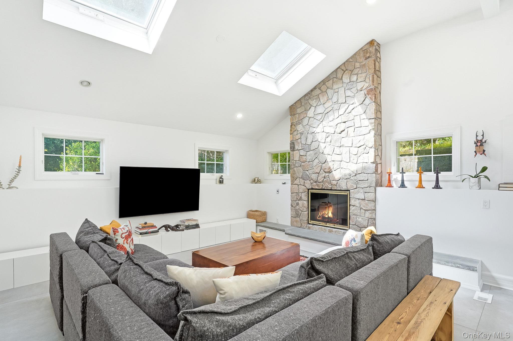 60 Hillside Lane New Rochelle, NY 10804 - Photo 19 of 44 a living room with furniture a fireplace and a flat screen tv