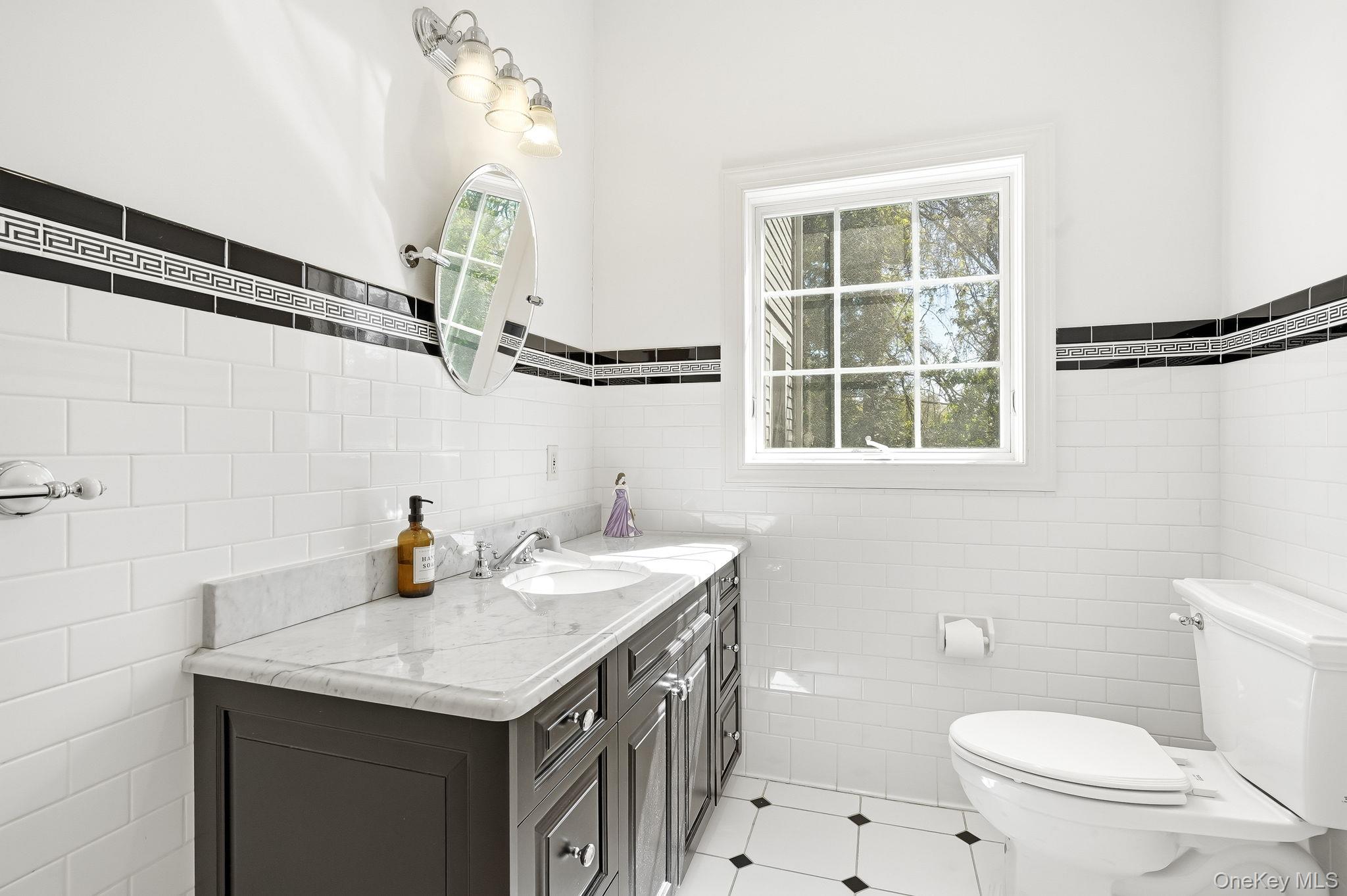 60 Hillside Lane New Rochelle, NY 10804 - Photo 21 of 44 a bathroom with a sink a toilet and a window