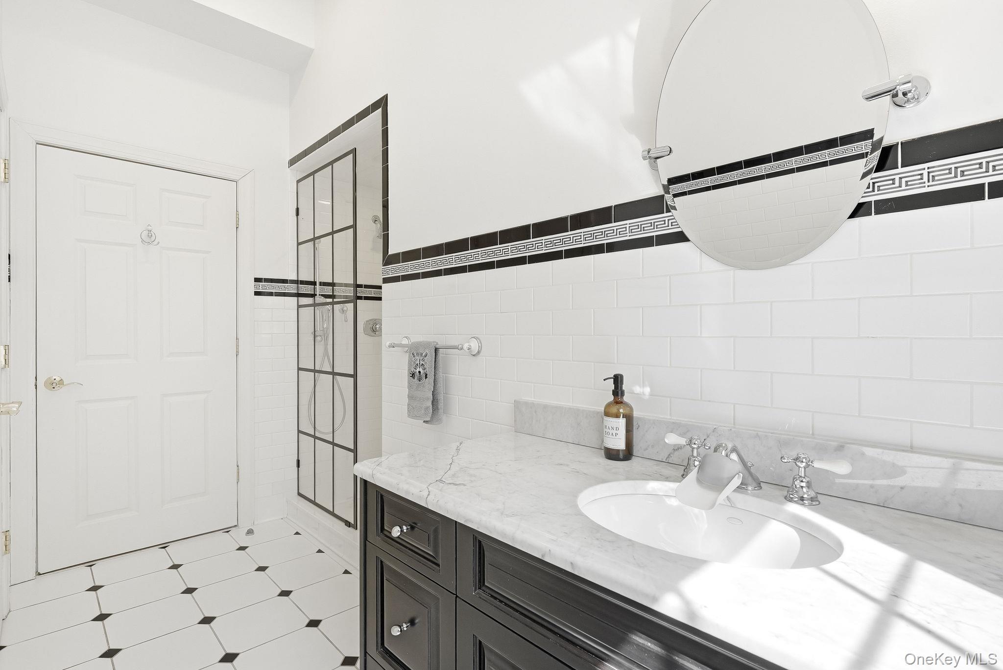 60 Hillside Lane New Rochelle, NY 10804 - Photo 22 of 44 a bathroom with a granite countertop sink a mirror and shower