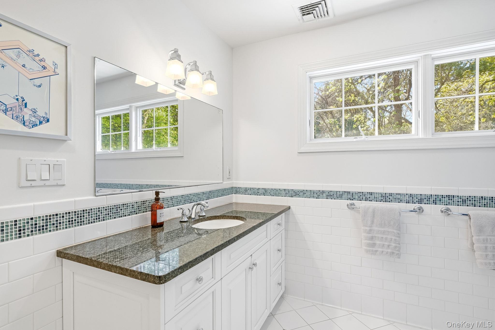 60 Hillside Lane New Rochelle, NY 10804 - Photo 30 of 44 a bathroom with a granite countertop sink a large mirror and a bathtub