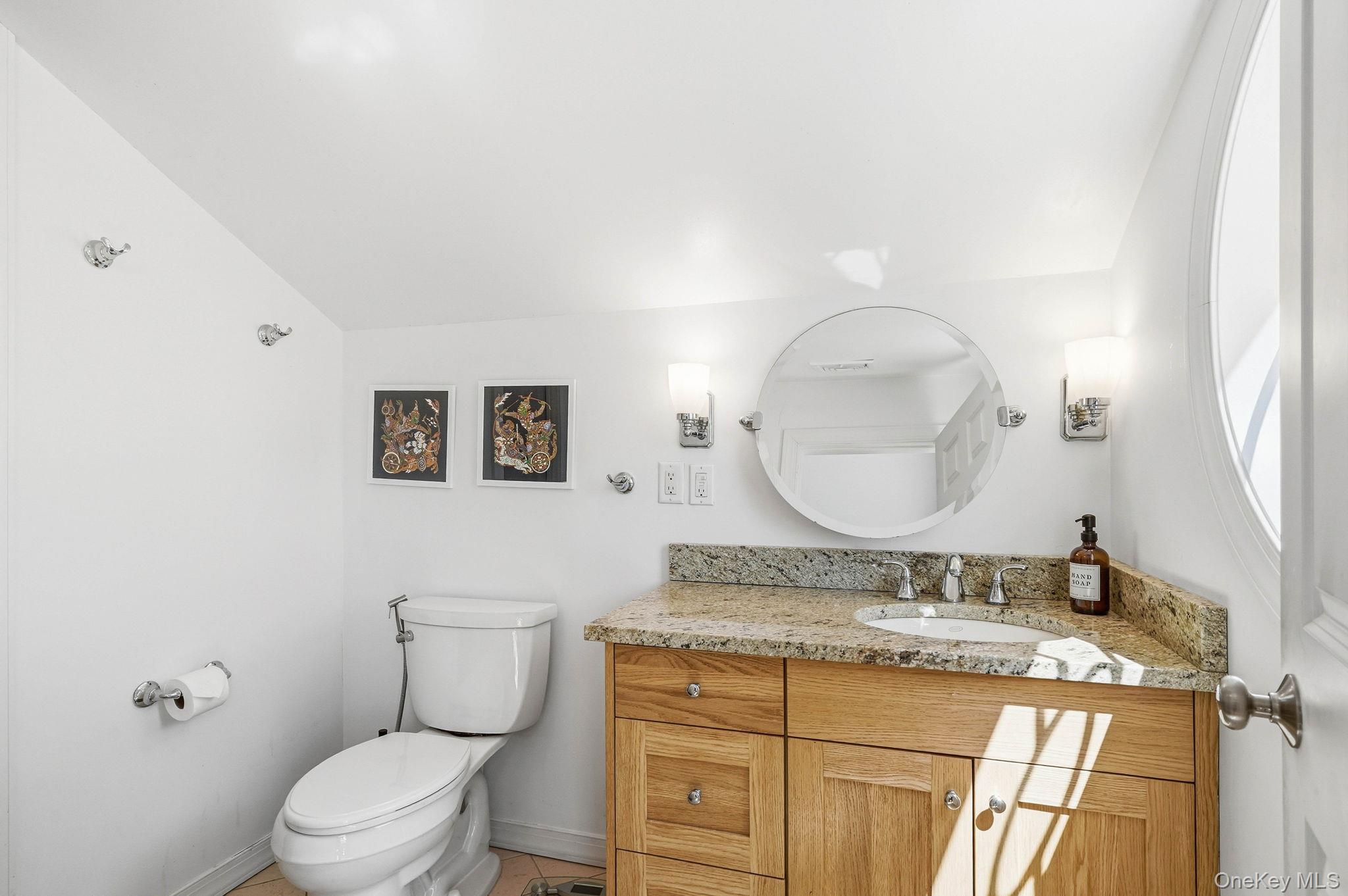 60 Hillside Lane New Rochelle, NY 10804 - Photo 34 of 44 a bathroom with a granite countertop toilet sink mirror and vanity