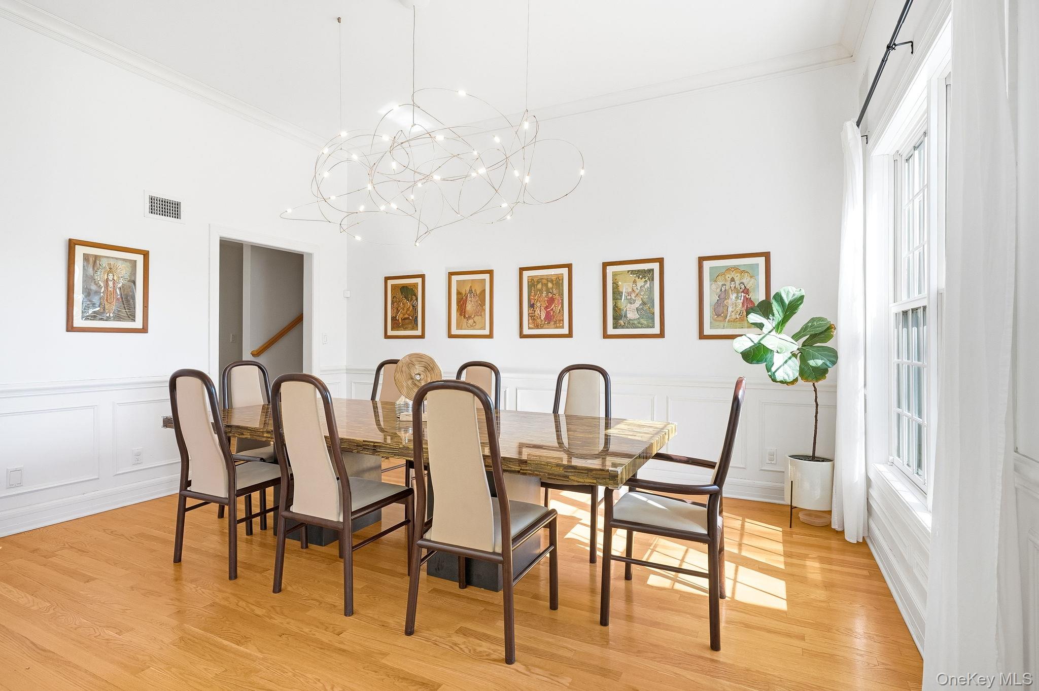60 Hillside Lane New Rochelle, NY 10804 - Photo 8 of 44 a view of a dining room with furniture a chandelier and wooden floor