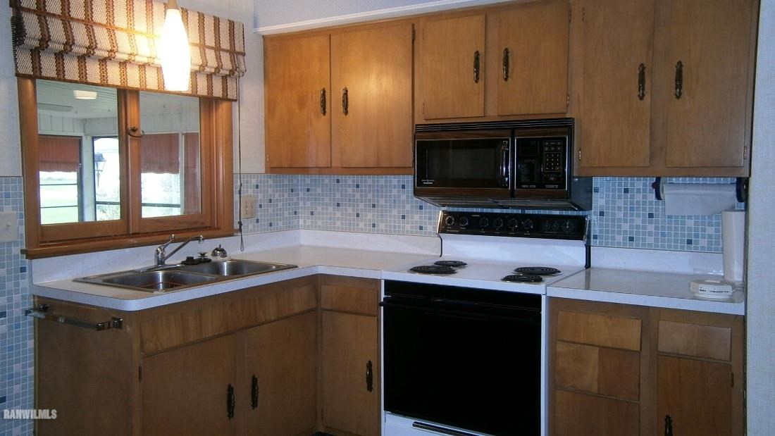 314 South Ridge Street Shannon, IL 61078 - Photo 7 of 15 a kitchen with stainless steel appliances granite countertop a sink stove and microwave