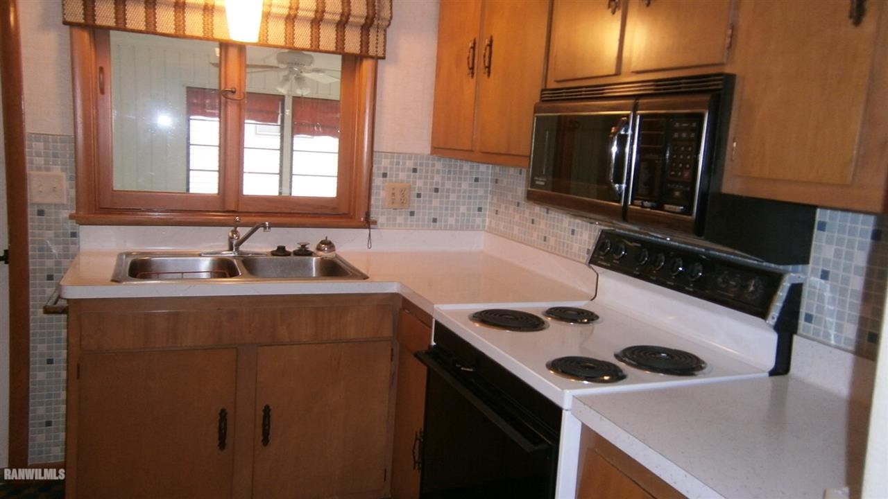 314 South Ridge Street Shannon, IL 61078 - Photo 8 of 15 a kitchen with a sink a stove and microwave