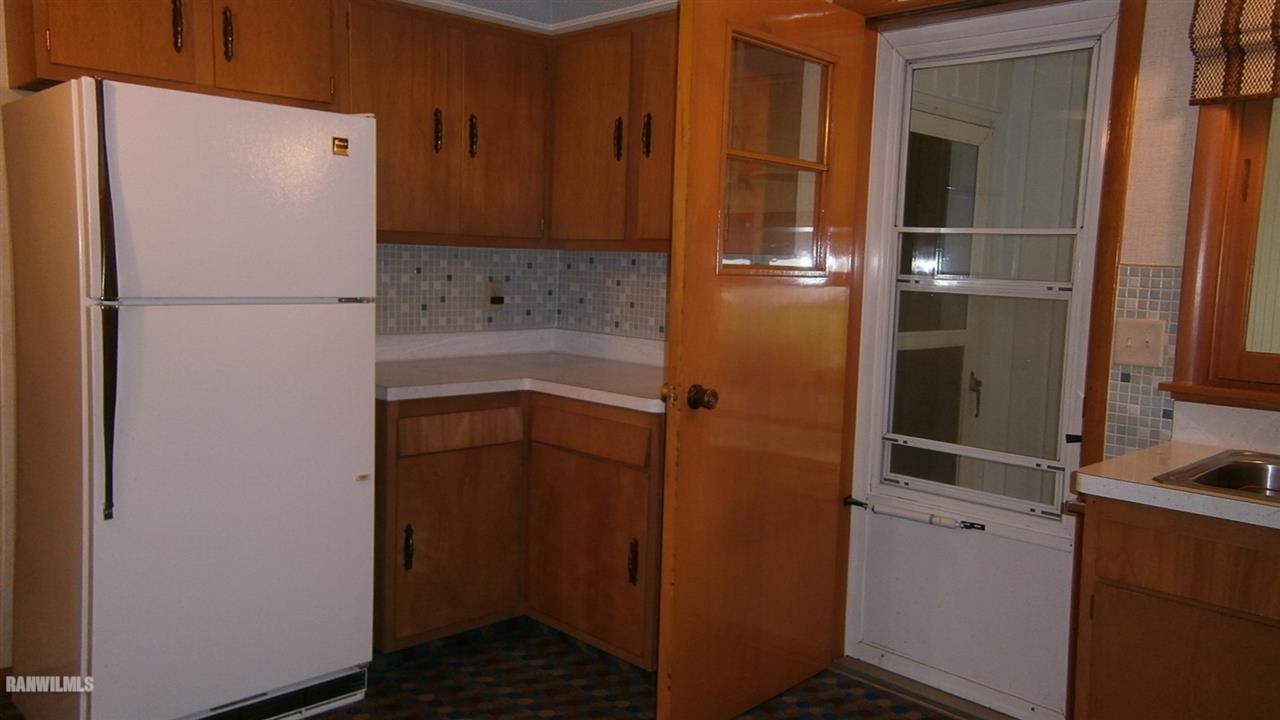314 South Ridge Street Shannon, IL 61078 - Photo 9 of 15 a utility room with wooden floor and cabinets
