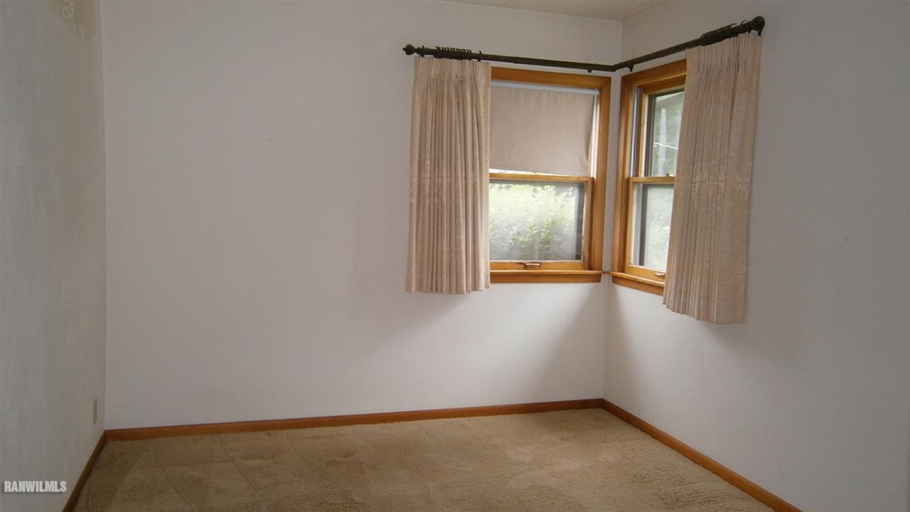 314 South Ridge Street Shannon, IL 61078 - Photo 10 of 15 a view of an empty room with wooden floor and a window