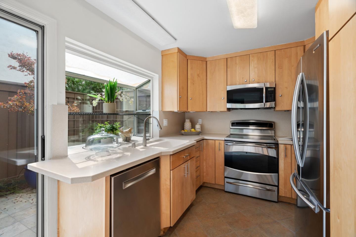 1032 Strayer Drive San Jose, CA 95129 - Photo 13 of 31 a kitchen with stainless steel appliances a stove sink microwave and refrigerator