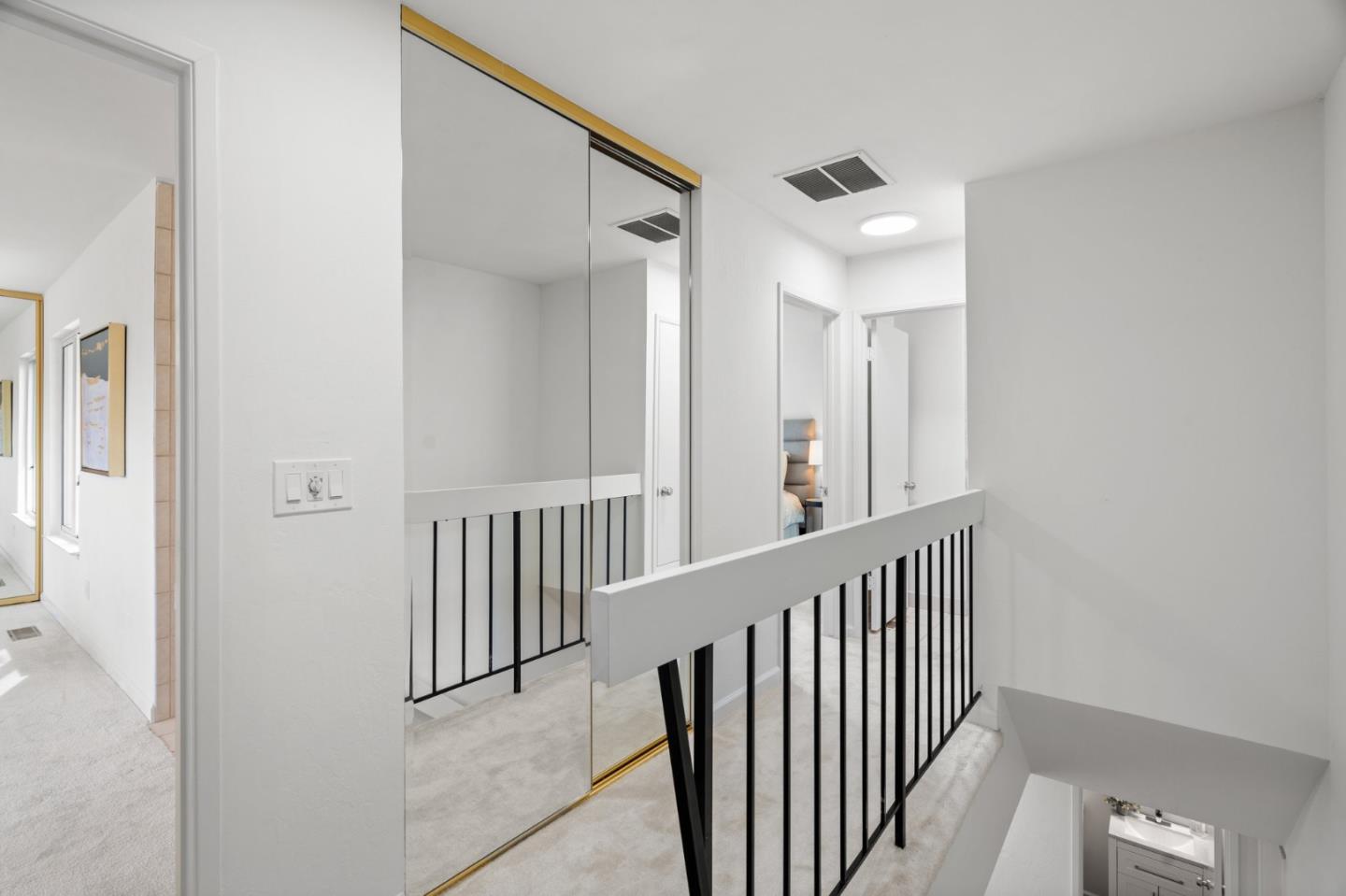 1032 Strayer Drive San Jose, CA 95129 - Photo 19 of 31 a view of a hallway with wooden floor and staircase