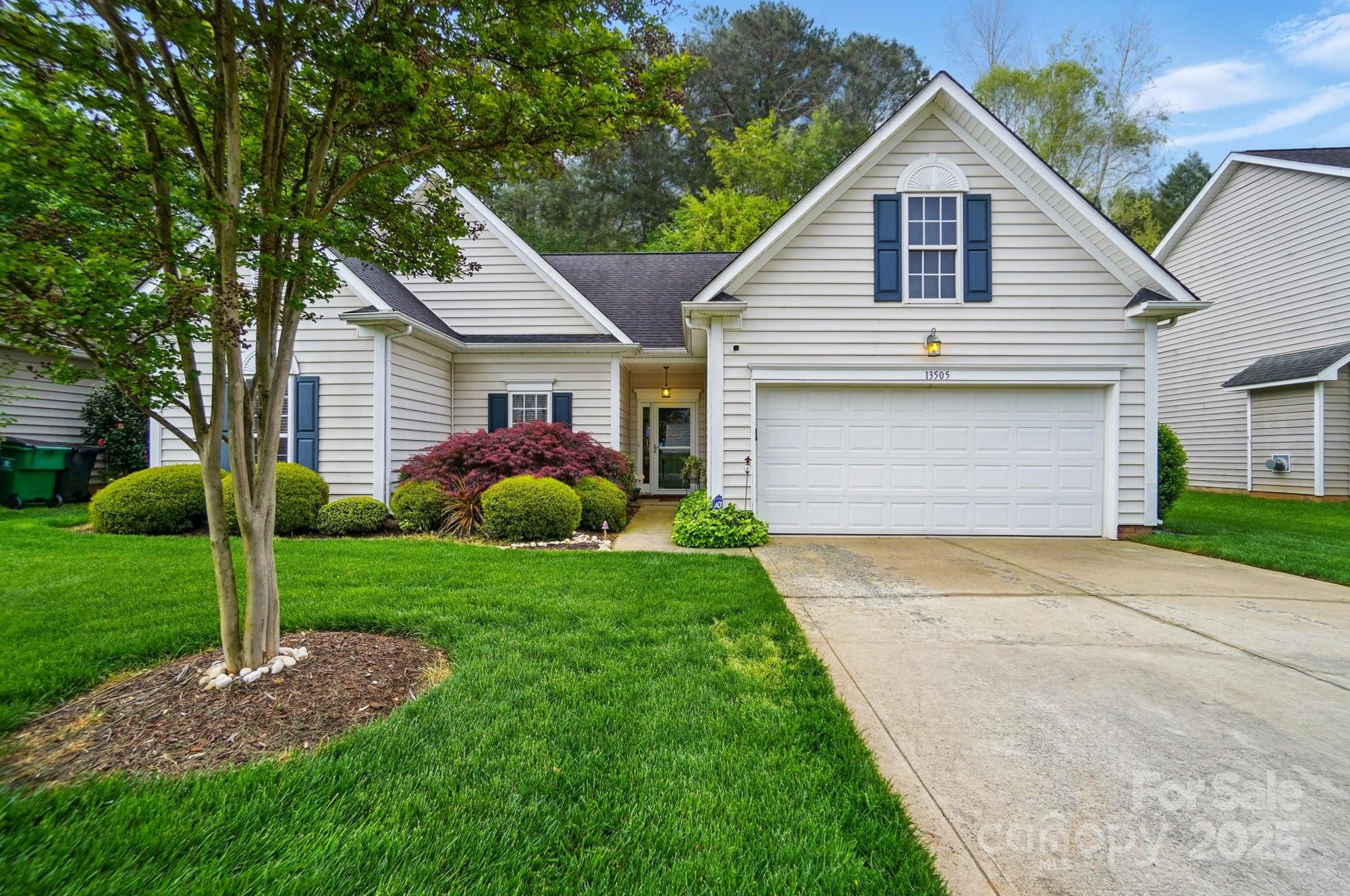 a front view of house with yard and green space