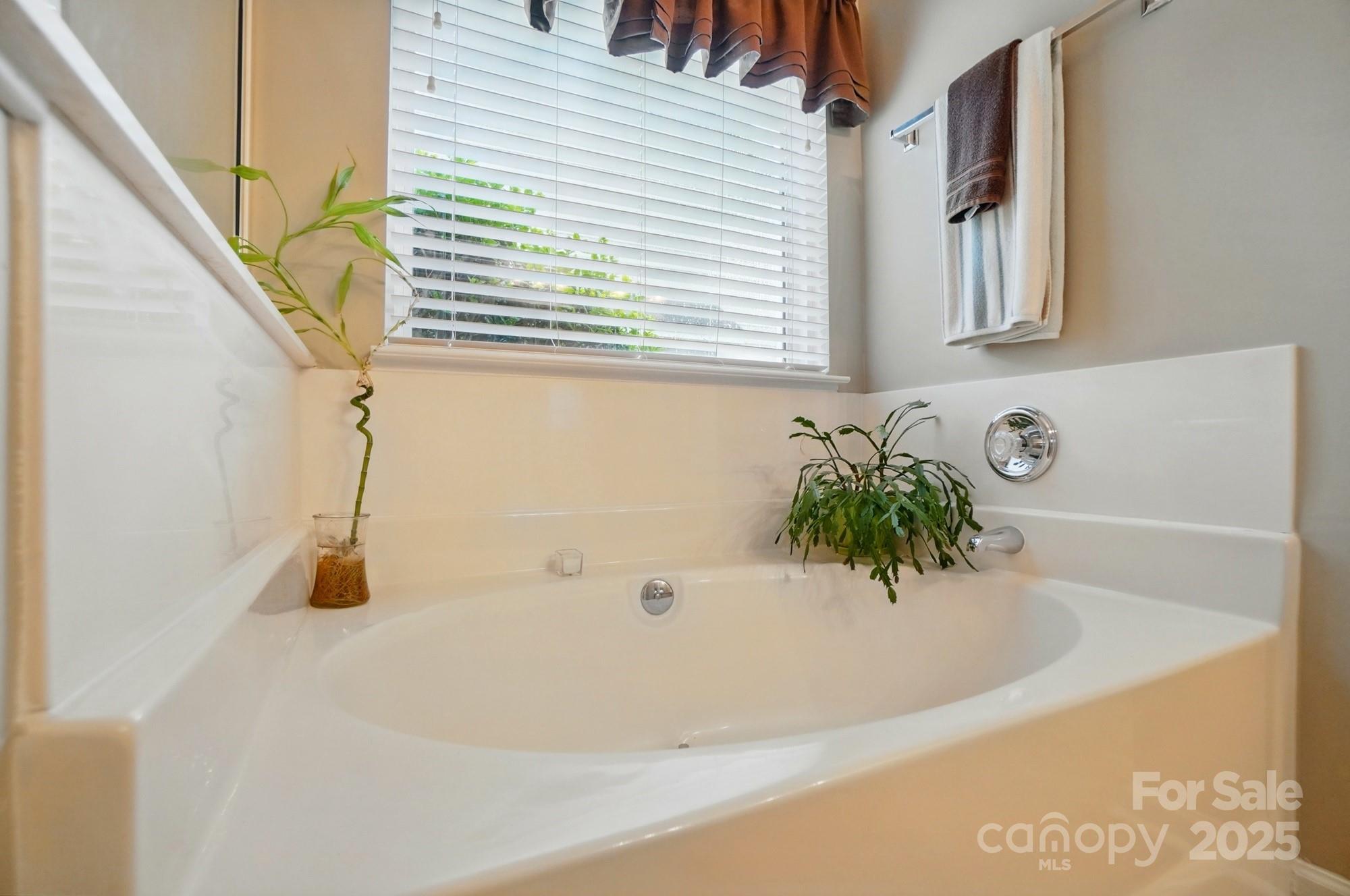13505 Michael Lynn Road Charlotte, NC 28278 - Photo 15 of 24 a white bath tub sitting next to a window