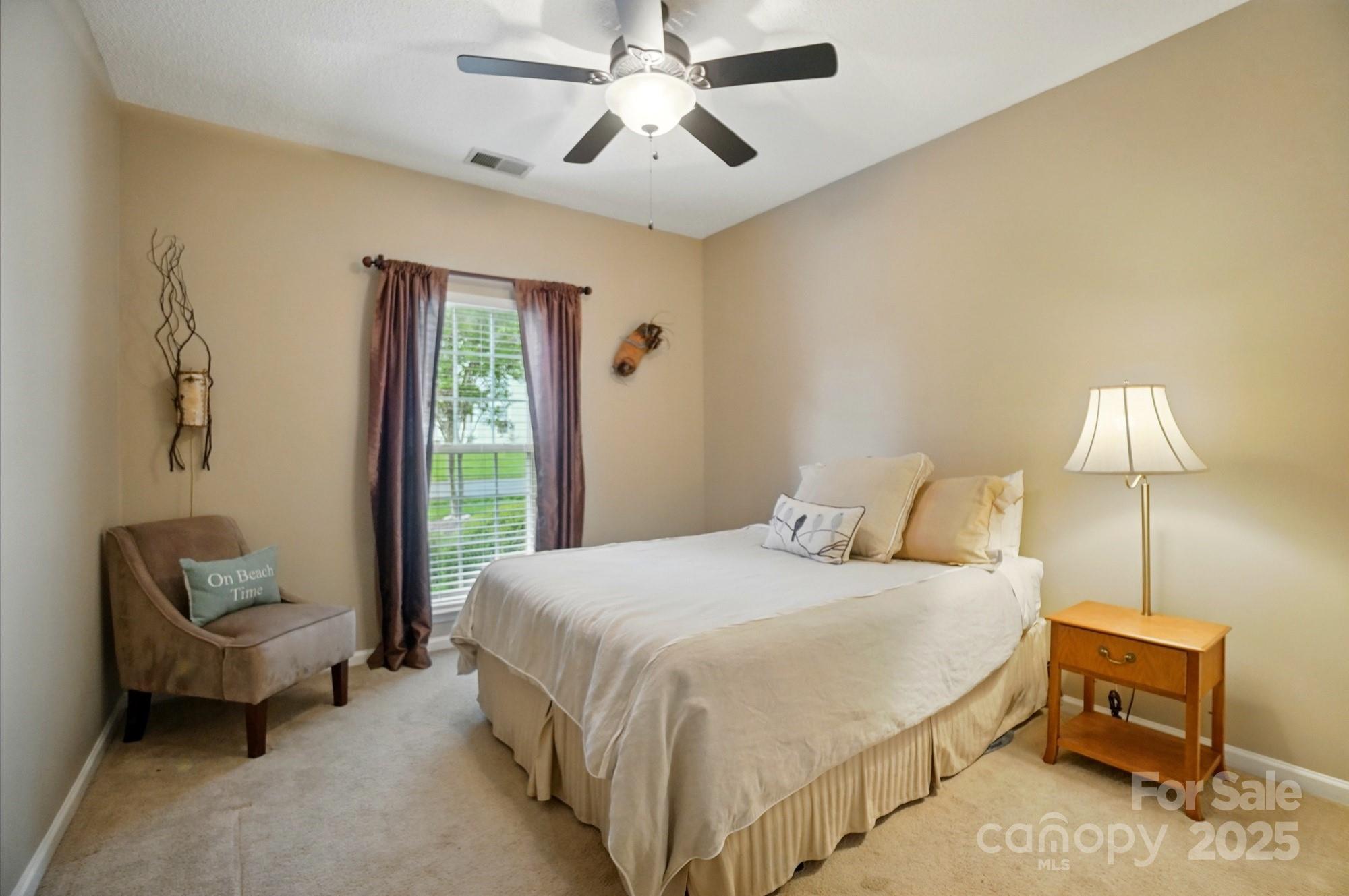 13505 Michael Lynn Road Charlotte, NC 28278 - Photo 18 of 24 a bedroom with a bed and a chair