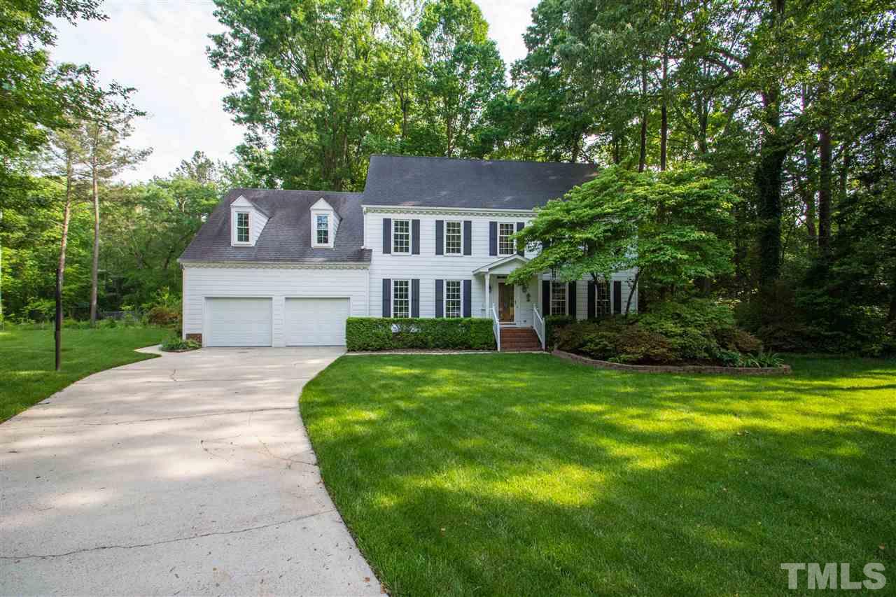 8000 Running Cedar Trail Raleigh, NC 27615 - Photo 1 of 18 a front view of a house with a garden