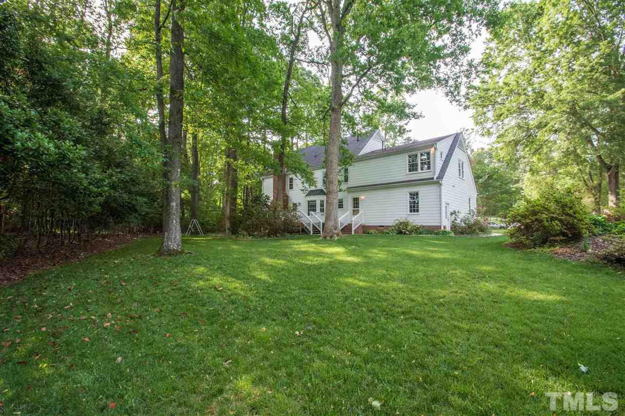8000 Running Cedar Trail Raleigh, NC 27615 - Photo 15 of 18 a view of a house with backyard and a tree