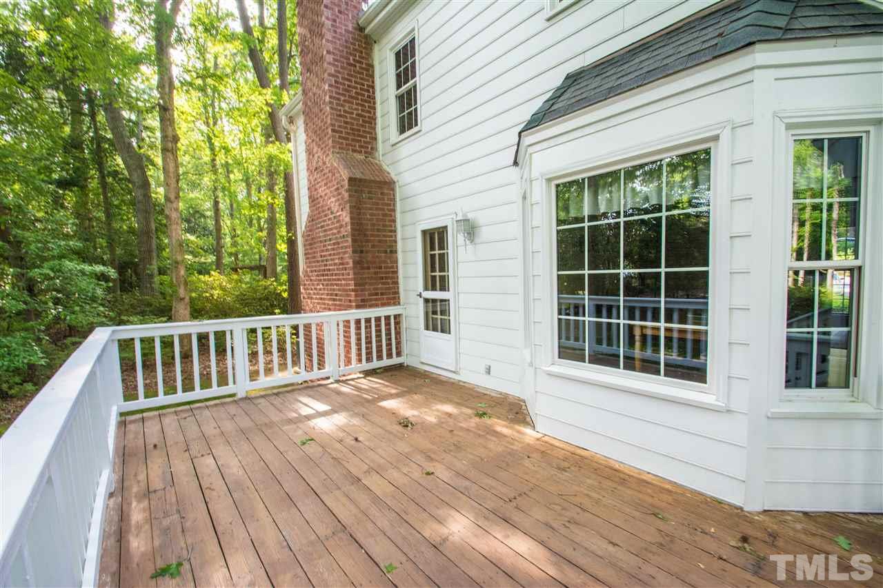 8000 Running Cedar Trail Raleigh, NC 27615 - Photo 17 of 18 a view of backyard with deck and wooden floor
