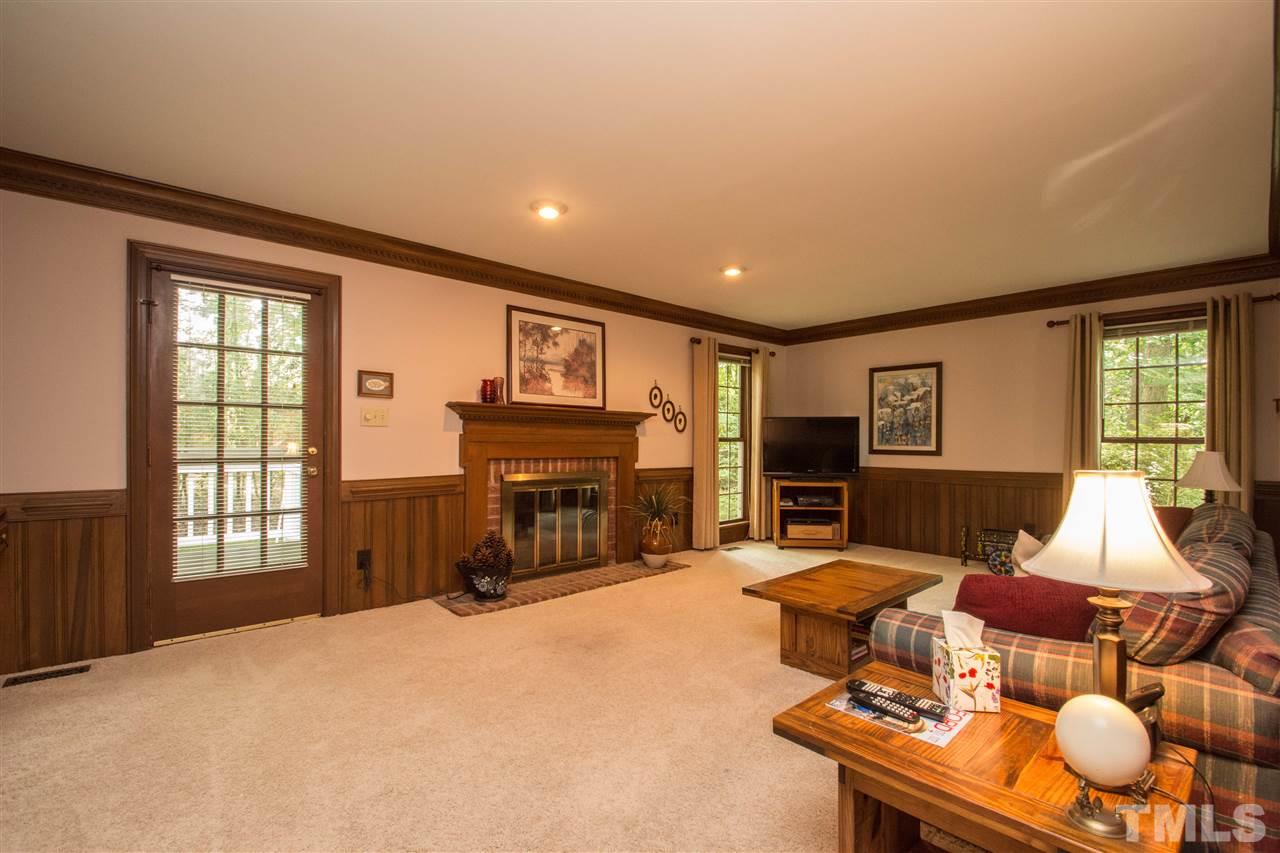 8000 Running Cedar Trail Raleigh, NC 27615 - Photo 3 of 18 a living room with furniture a fireplace and a window