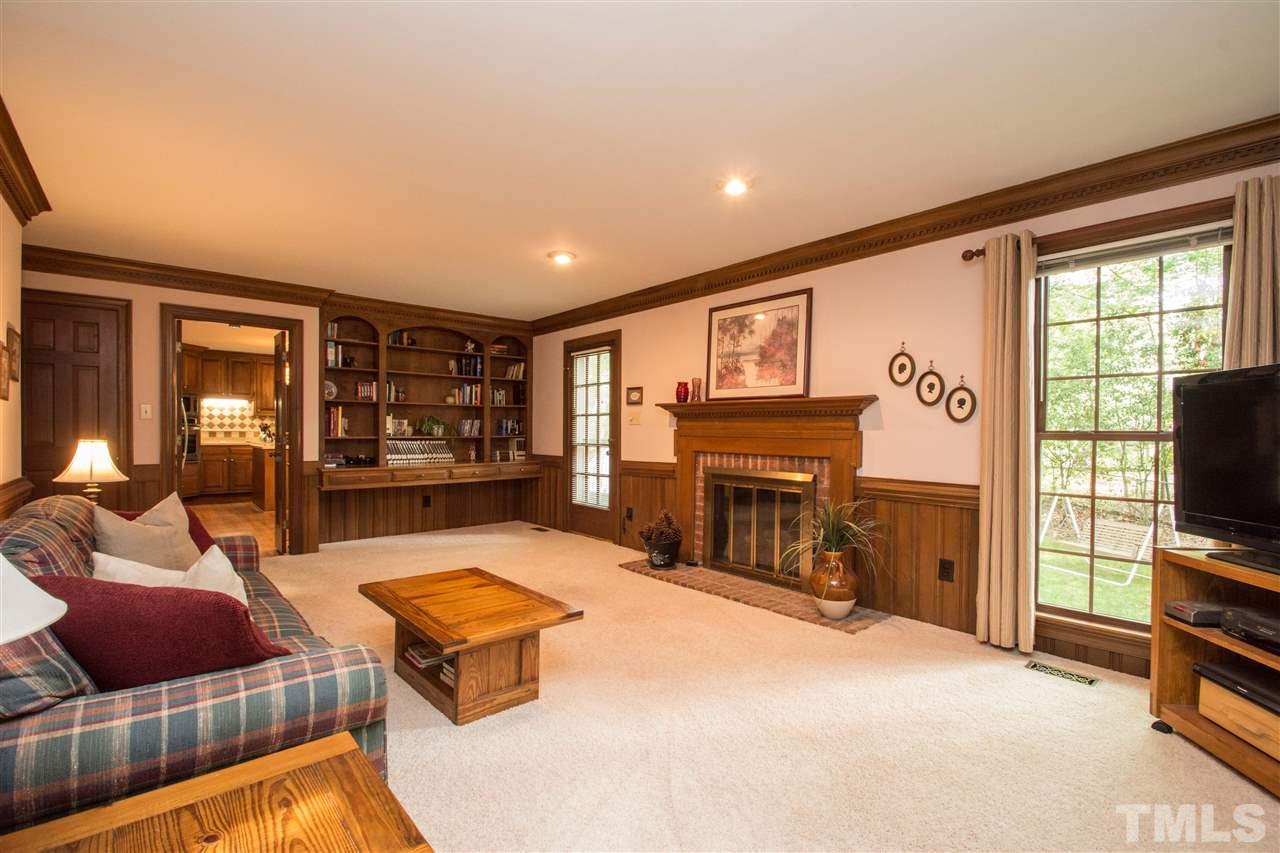 8000 Running Cedar Trail Raleigh, NC 27615 - Photo 4 of 18 a living room with furniture flat screen tv and a fireplace
