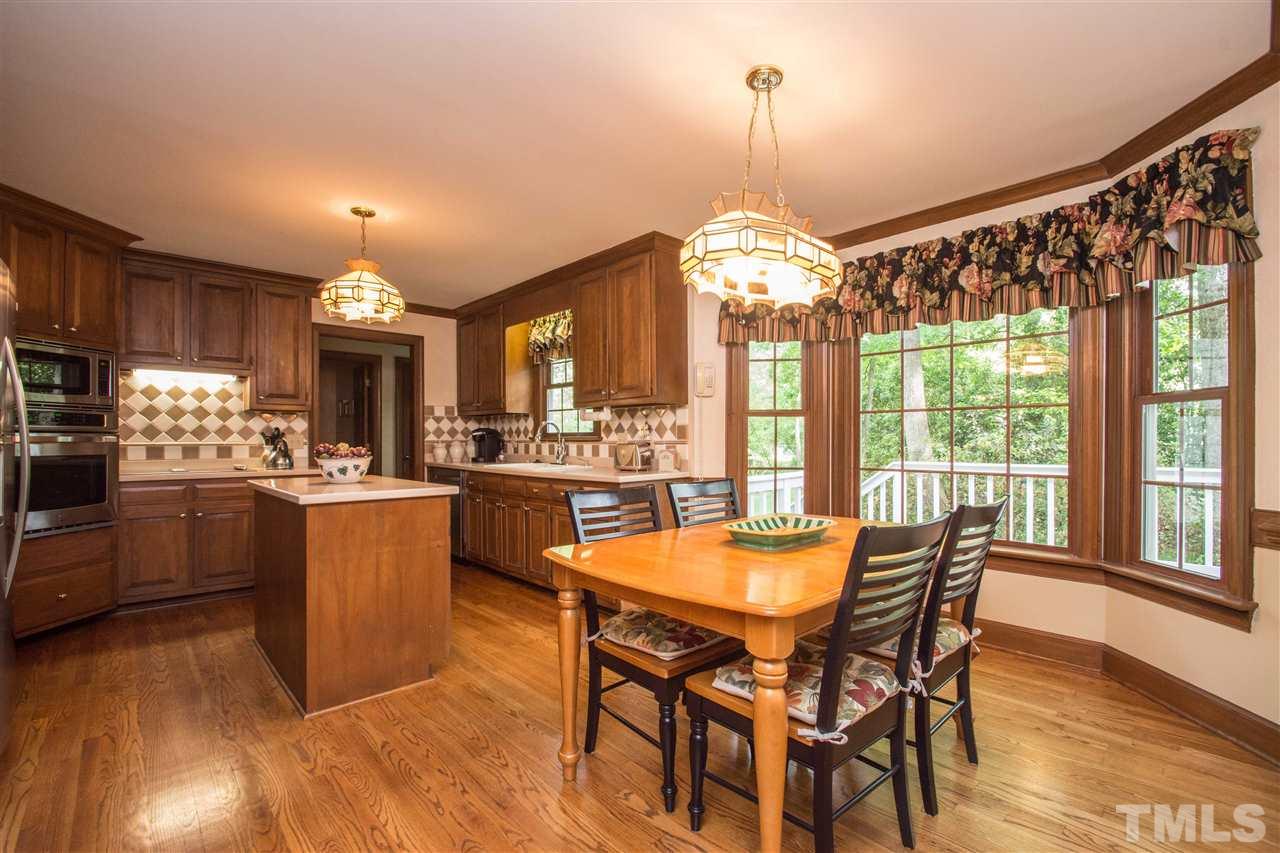 8000 Running Cedar Trail Raleigh, NC 27615 - Photo 5 of 18 a dining room and kitchen with a table chairs a workspace