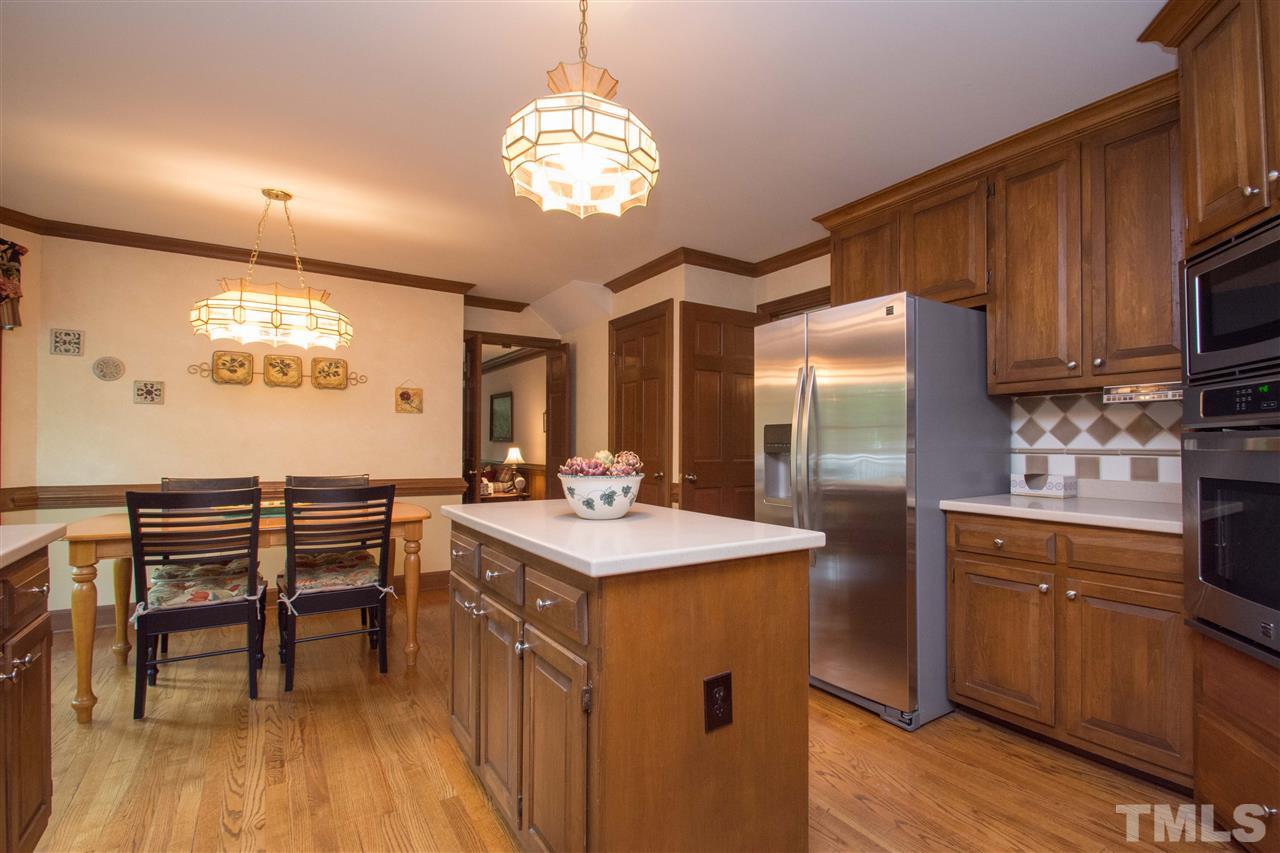 8000 Running Cedar Trail Raleigh, NC 27615 - Photo 6 of 18 a kitchen with kitchen island granite countertop a sink a counter space appliances and cabinets