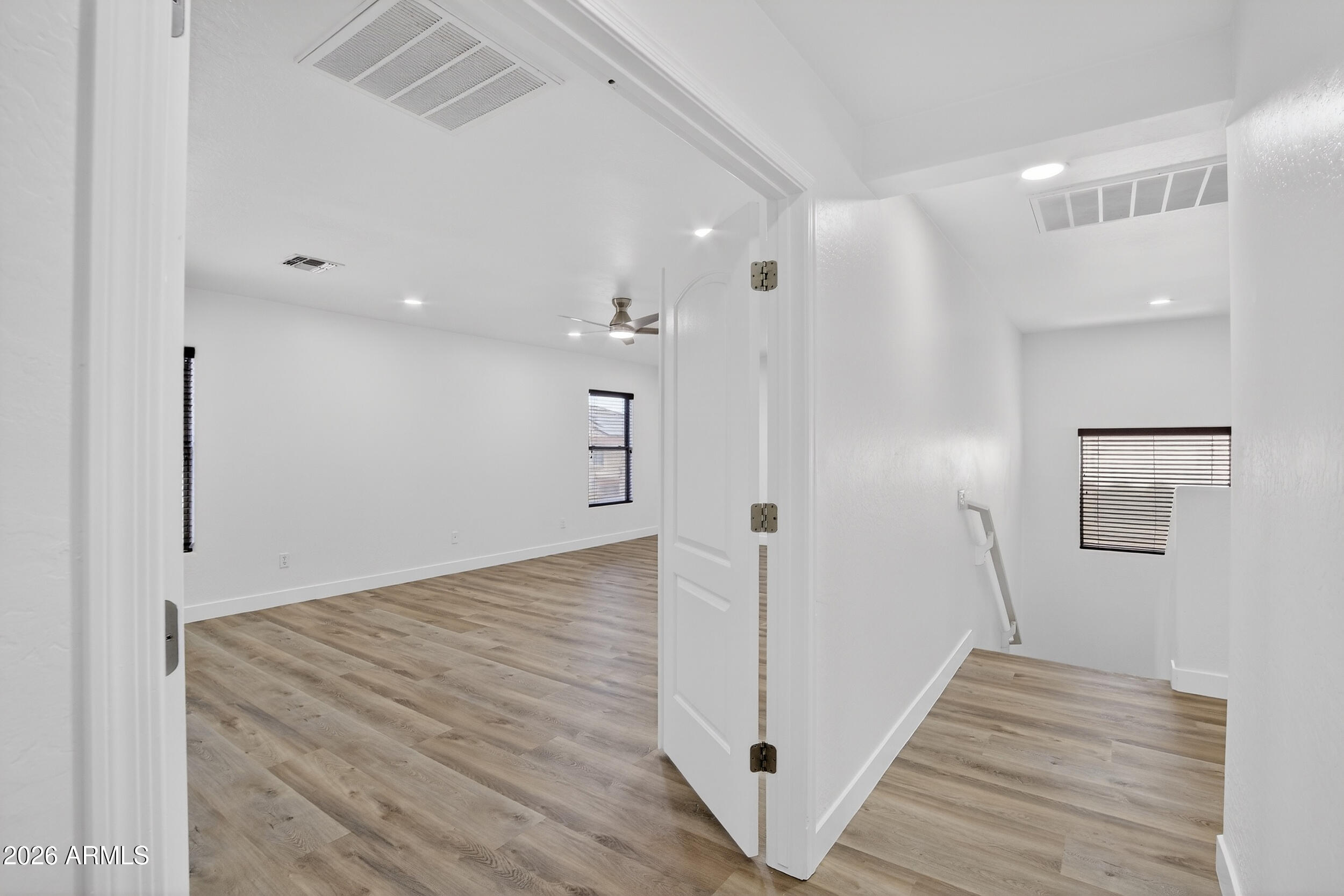 43620 West Cowpath Road Maricopa, AZ 85138 - Photo 29 of 60 a view of a hallway with wooden floor