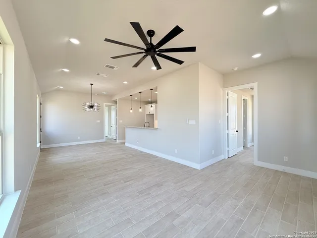 a view of a livingroom with a ceiling fan and window