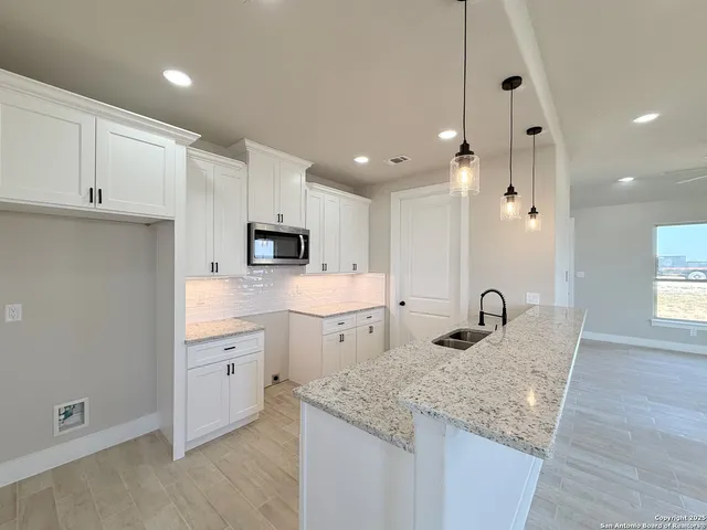 a kitchen with appliances cabinets and a sink