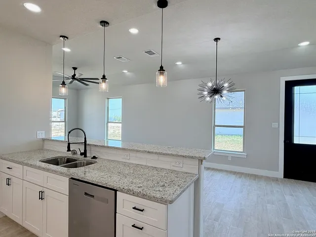 a kitchen with sink granite and window