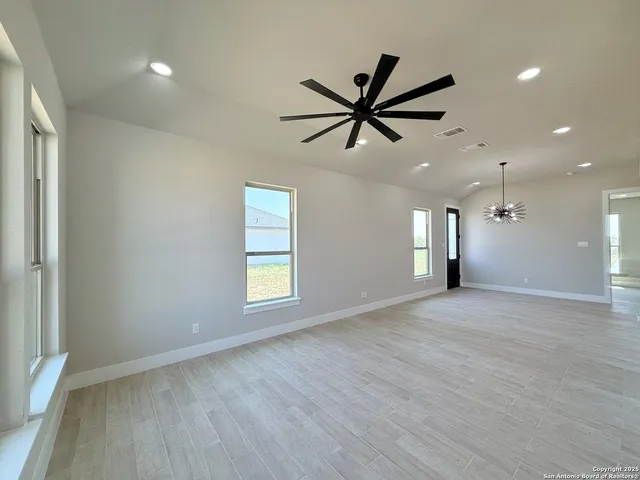 a view of a livingroom with a ceiling fan and window